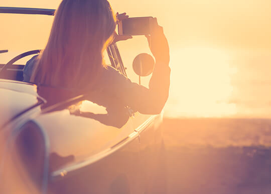 Woman Taking Photo from Car